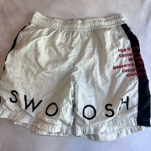 Nike athletic white shorts with mask swoosh wearing black stripe men’s